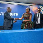 Kwamina-Asomaning-CE-Stanbic-Bank-Ghana-and-Dr.-Folasade-Femi-Lawal-Country-Manager-and-Area-Business-Head-West-Africa-at-Mastercard-in-a-handshake-after-the-signing