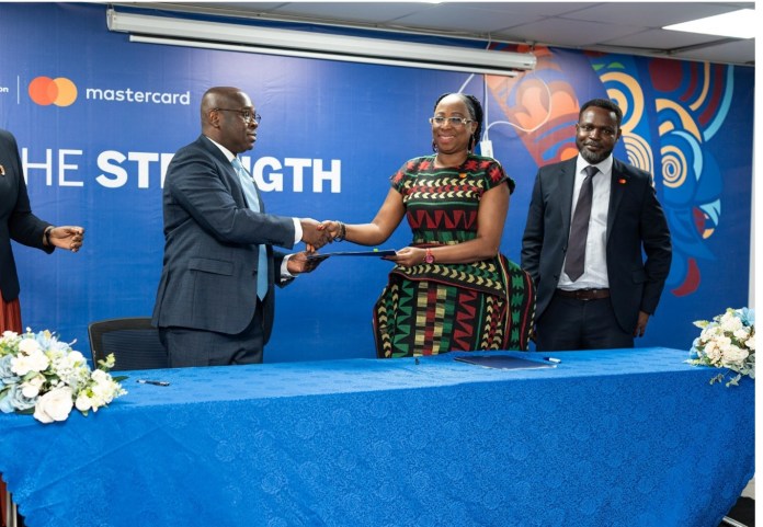 Kwamina-Asomaning-CE-Stanbic-Bank-Ghana-and-Dr.-Folasade-Femi-Lawal-Country-Manager-and-Area-Business-Head-West-Africa-at-Mastercard-in-a-handshake-after-the-signing